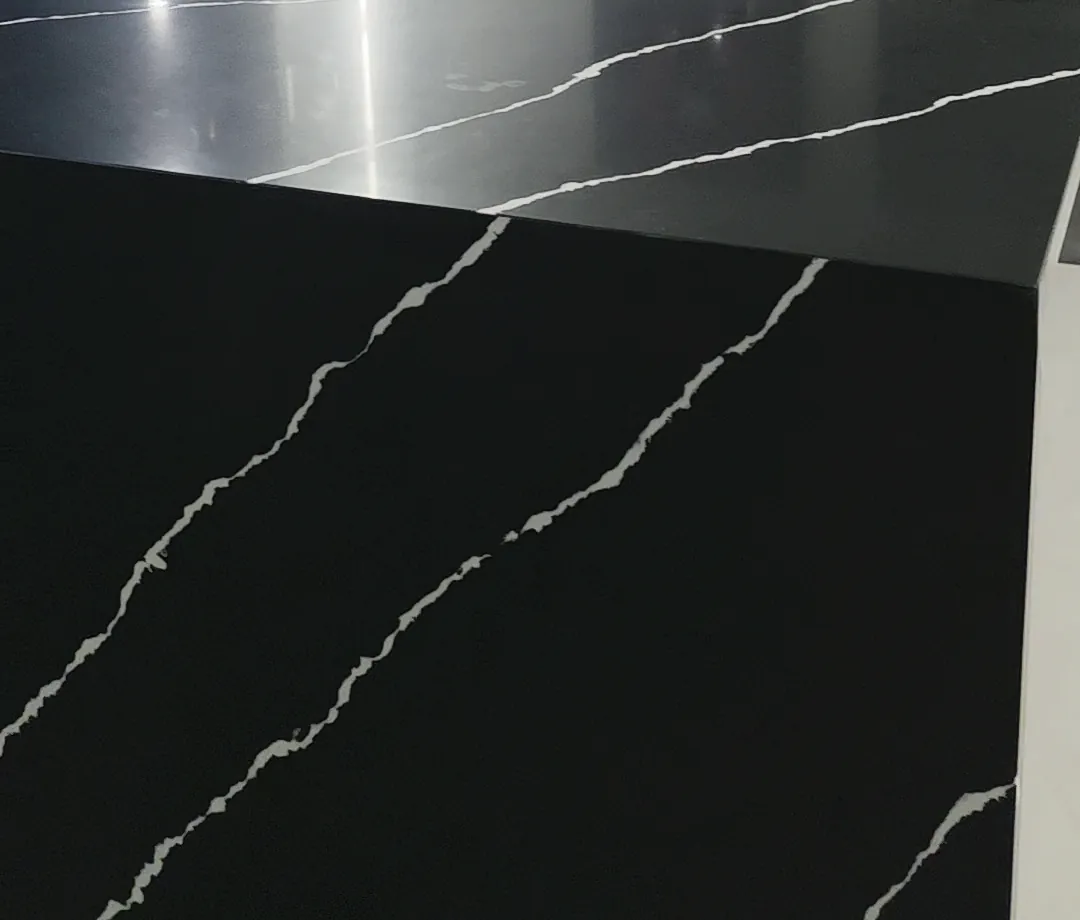 Close-up of white veining running across the top and down the side of a black stone island